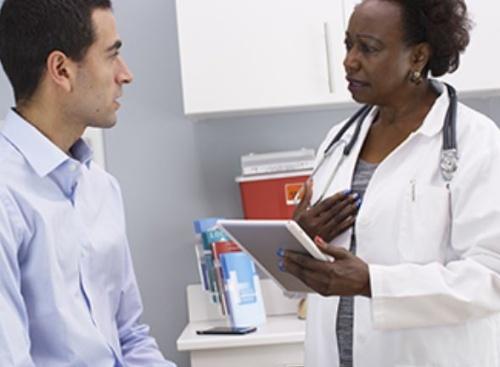 A female physician speaking to a male patient