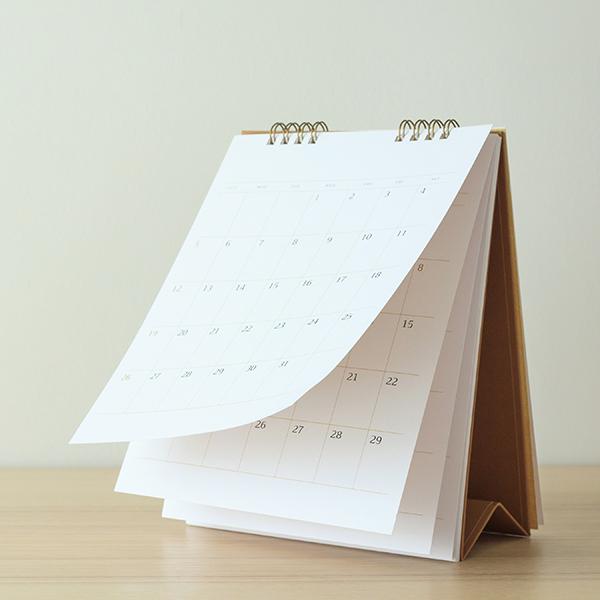 Calendar page flipping sheet on wood table