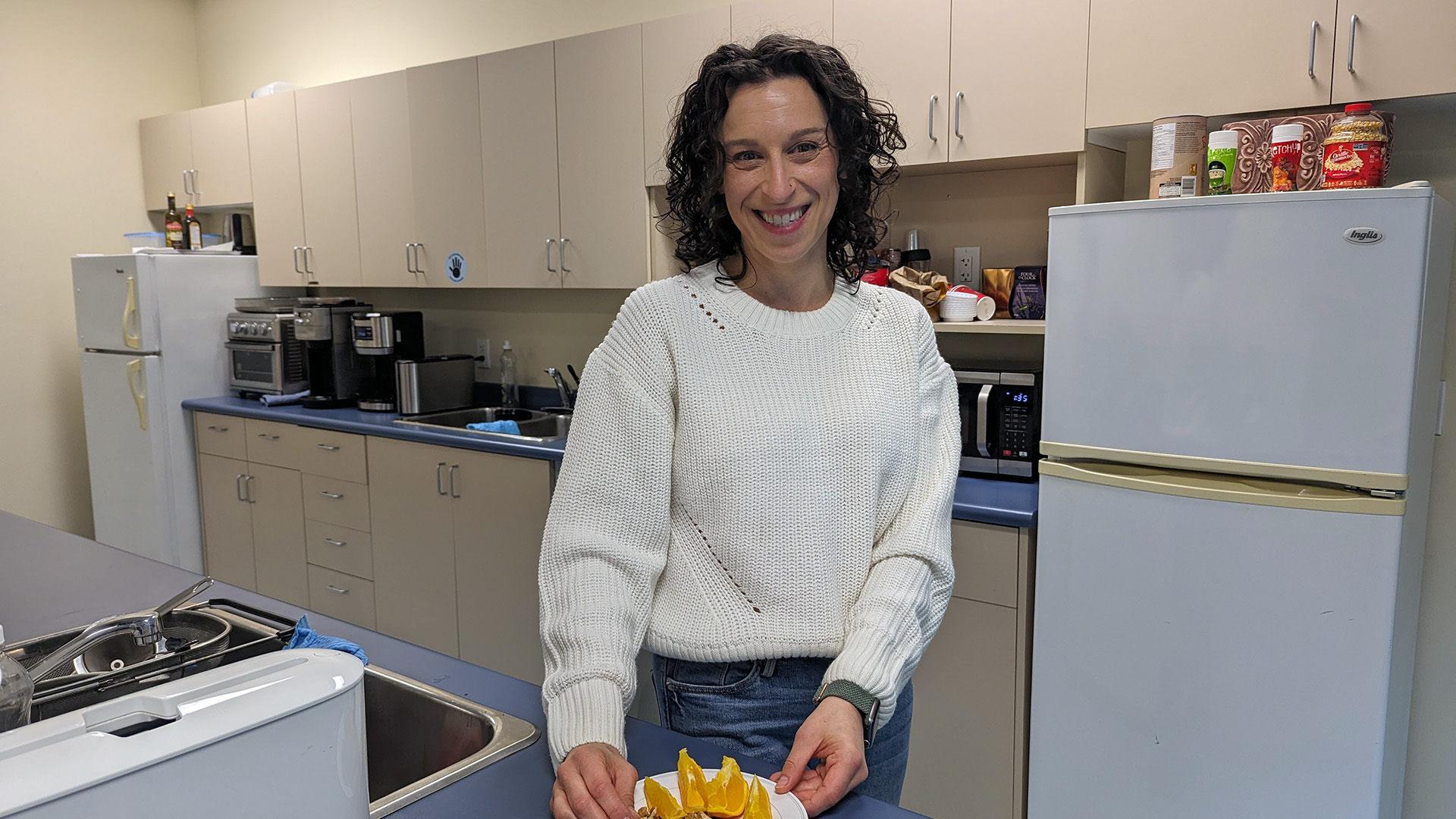 Image of Ilana, registered dietitian, in a kitchen with a healthy snack in front of her.