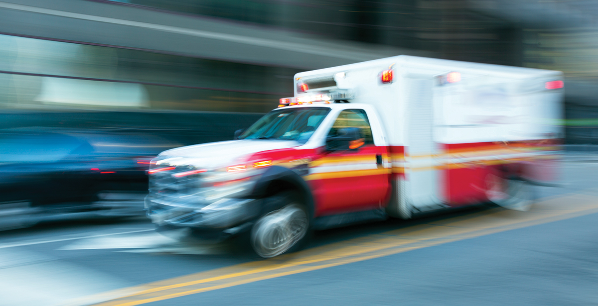 Ambulance driving fast with blurred background