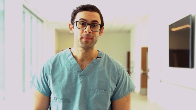 A photo of Dr. Taher in scrubs