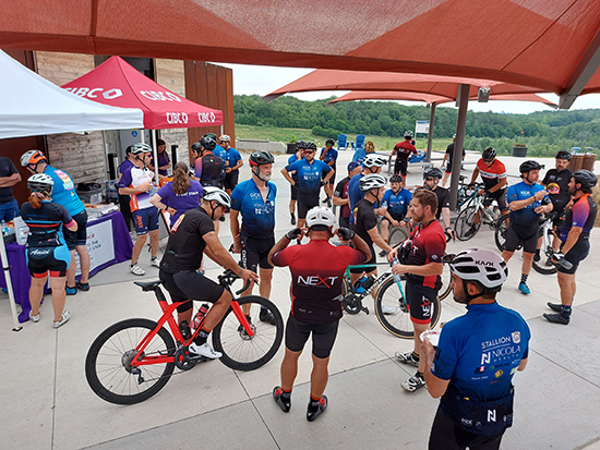 Cyclists resting and chatting at one of the event pit-stops